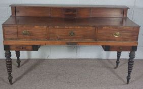 A George III and later mahogany sideboard, formerly a box piano, with turned legs