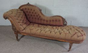 A mid Victorian chaise longue, circa 1870, with a scrolled and button upholstered back, and turned