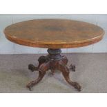 A Victorian walnut oval loo table, mid 19th century, with an hinged top set on a pedestal base