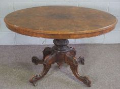 A Victorian walnut oval loo table, mid 19th century, with an hinged top set on a pedestal base