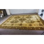 A large Caucasian style carpet, decorated with medallions, with light yellow motifs on cream ground,