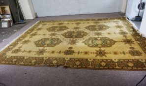 A large Caucasian style carpet, decorated with medallions, with light yellow motifs on cream ground,