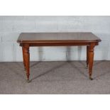 A Victorian mahogany console table, with rounded rectangular top on turned tapered legs with castors