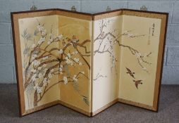 A Japanese decorative four fold screen, early 20th century, painted with finches on a flowering