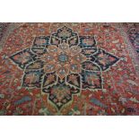 An Isfahan rug, 20th century, with a central star medallion on a red ground within guard stripes,