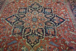 An Isfahan rug, 20th century, with a central star medallion on a red ground within guard stripes,