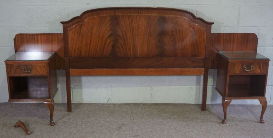 A large mahogany veneered bedhead, with integral bedside cabinets
