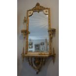 A Regency composition gilt and painted pier mirror, late 19th century, with a shaped rectangular