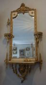 A Regency composition gilt and painted pier mirror, late 19th century, with a shaped rectangular