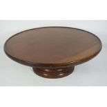 A mahogany ‘Lazy Susan’, with circular top rotating on a spreading circular foot, 20th century, 53cm