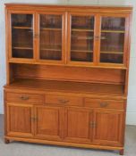 A large hardwood china display cabinet, modern, with glazed cabinets over a base with three