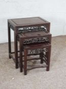 A Chinese Hong-Mu nest of three occasional tables, each with a pierced and carved frieze, 56cm high,