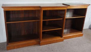 A large breakfront open bookcase, circa 1900, with three flights of adjustable shelves on a plinth