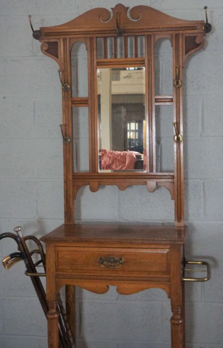 An Edwardian oak hall stand, circa 1910, with a shaped mirror set back with seven hat hooks, over - Image 2 of 8