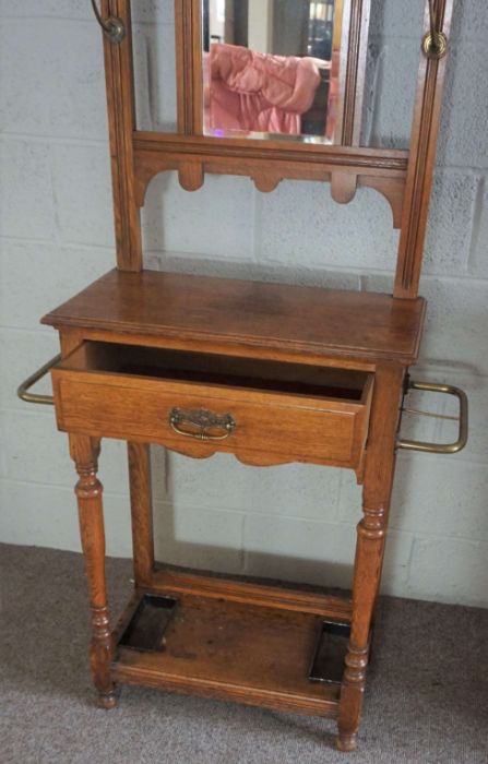 An Edwardian oak hall stand, circa 1910, with a shaped mirror set back with seven hat hooks, over - Image 5 of 8