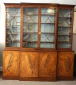 A George III mahogany breakfront library bookcase, circa 1780, manner of John Mayhew,  with a