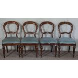 A set of four Victorian mahogany balloon backed dining chairs, late 19th century, with tapered and