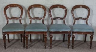 A set of four Victorian mahogany balloon backed dining chairs, late 19th century, with tapered and