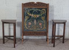 An oak framed tapestry fire screen, decorated with flowers, 79cm high; together with two small