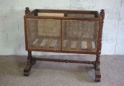 A George IV mahogany framed child’s crib, 19th century, the rectangular caned crib set on twin