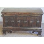 An oak coffer, 16th century and later, with a lightly curved hinged lid, over a triple arch