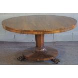 A William IV rosewood breakfast table, circa 1830, with a round tilt top set on an octagonal tapered