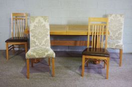 A modern oak draw-leaf dining table and two pairs of related dining chairs, two with slats, two