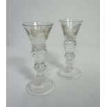 A pair of Jacobite cordial glasses, circa 1830, each with a rose engraved trumpet glass bowl, with