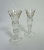 A pair of Jacobite cordial glasses, circa 1830, each with a rose engraved trumpet glass bowl, with