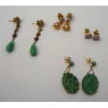 A pair of jadeite carved oval ear pendant earrings, together with another pair; also a pair of