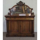 A mid Victorian mahogany chiffonier, circa 1850, with a scrolled mirrored back centred by stiff