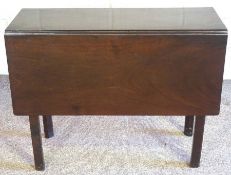 A George III mahogany drop leaf table, with a rectangular top and chamfered legs