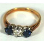 A sapphire and diamond three stone engagement ring, 18 carat gold setting, ring size J, the