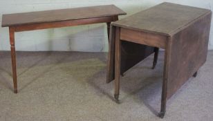 A George III style drop leaf table, with a rectangular top and square section legs with brass caps