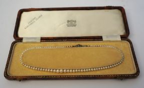 A vintage necklace of graduated cultured pearls, set with a silver clasp, 42cm long, with fitted