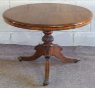 A Victorian walnut breakfast or loo table, circa 1870, with a moulded circular top on a turned and