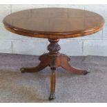 A Victorian walnut breakfast or loo table, circa 1870, with a moulded circular top on a turned and
