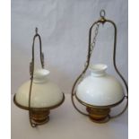 A pair of Victorian suspended brass oil lamps, marked ‘Lampe Veritas’, with domed white glass shades