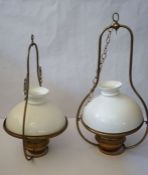 A pair of Victorian suspended brass oil lamps, marked ‘Lampe Veritas’, with domed white glass shades