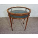 A late Regency oval mahogany vitrine table, 19th century, with a hinged glazed lid and clear