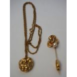 A 14 carat gold layered relief pendent, set on a 12 carat marked chain, 9g (gross); also a similar