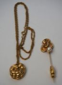 A 14 carat gold layered relief pendent, set on a 12 carat marked chain, 9g (gross); also a similar