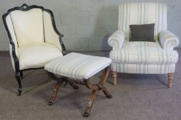 An ebonized fauteuil armchair, 20th century, with cream upholstery; together with a Georgian style