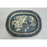 A very large blue and white ‘Willow Pattern’ meat ashet or platter, stamped ‘Best Goode’, 54cm wide;