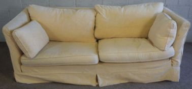 A pair of modern cream upholstered three seat sofas, loose covers and low backs, 210cm wide (2)