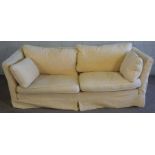 A pair of modern cream upholstered three seat sofas, loose covers and low backs, 210cm wide (2)