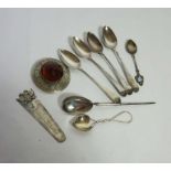 A small group of silver including a four Georgian silver tea spoons, a white metal book mark, with
