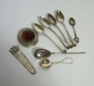 A small group of silver including a four Georgian silver tea spoons, a white metal book mark, with