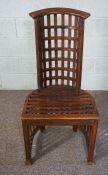 An interesting stained beechwood lattice chair, with bowed pierced back and slatted base, 110cm