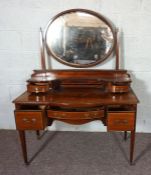 An Edwardian mahogany and line inlaid dressing table, with a matching bedside cabinet, circa 1910,